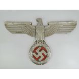 An aluminium WWII German eagle over swastika train plaque having red paint detail.