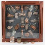 A collection of antique jelly / mousse moulds, approximately 32 (28 mounted in a display),