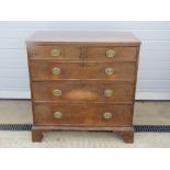 A late Georgian oak chest of two short over three long drawers having bracket feet,