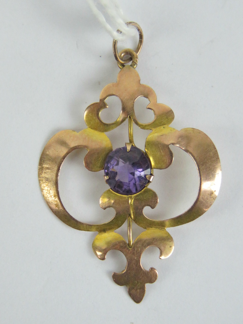 A 9ct gold art nouveau pendant of floral form, having central round cut amethyst, stamped 9ct, 3.