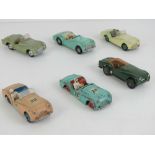 Three Dinky Toys Triumph TR2 cars, together with another (tyres deficient), a Corgi Triumph TR3,