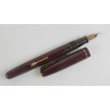 A vintage Watermans 'self-filler' fountain pen with original 14ct gold nib.