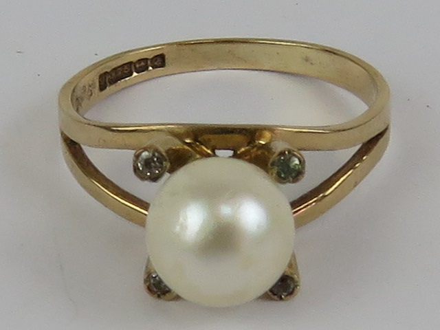 A 9ct gold and pearl ring, having four claw setting each having white stone inset, size K-L, 2.2g.