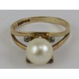 A 9ct gold and pearl ring, having four claw setting each having white stone inset, size K-L, 2.2g.