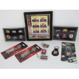 A framed set of Ferrari themed stamps together with two Official Ferrari keychains,