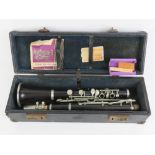 Clarinet: an old French Rosewood clarinet with spare reeds and in a case,
