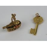 Two 9ct gold charms being a champagne bottle in basket and a '21' key, each hallmarked.