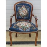 A delightful over-stuffed needlepoint decorated open-arm chair , shaped and carved throughout.