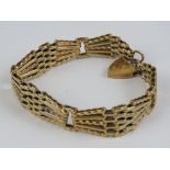 A 9ct gold geometric five bar bracelet with heart padlock clasp, hallmarked 375, 21g.