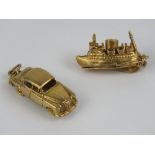 Two 9ct gold charms; one being a ship opening to reveal 'cars' within,