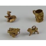 Three 9ct gold charms being tankard, goods cart and lion, each hallmarked.