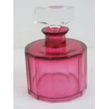 An Art Deco pink glass oversized scent bottle, square shaped stopper, all standing 14cm high.