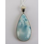 An unusual blue stone pendant of teardrop form, 5.6cm inc white metal bale.