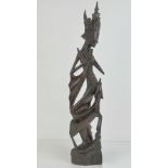 An Indo-Asian rosewood carved and pierced slender statuette, 57cm high.