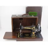 A vintage Singer sewing machine in case.