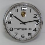 A Porsche themed wall clock having cream dial and black Arabic numerals, Quartz movement,
