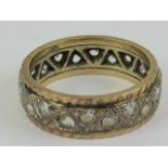 A 9ct gold eternity ring having geometric triangular pattern set with white stones, hallmarked 375,