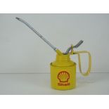 A 1/2 pint oil can having yellow ground with Shell logo upon.