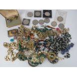 A quantity of assorted costume jewellery and commemorative coins.