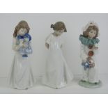 Three Nao figurines each being standing child, 21cm high.