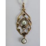 A 9ct gold and pearl Edwardian pendant having scroll work design frame, stamped 9ct (slightly worn),