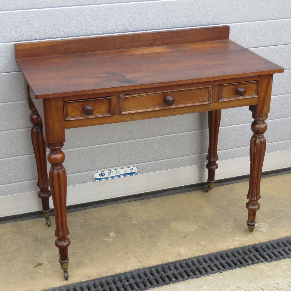 A late 19th century mahogany table having blank central drawer with twin box drawers to each side,