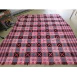 A well woven heavy Welsh style blanket having geometric design in reds,