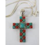 A silver crucifix set with faux coral and turquoise, stamped 925, on silver chain, 4.6cm inc bale.