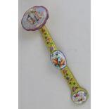 A Chinese Canton enamel on brass ruyi sceptre having deity and floral design upon yellow ground,