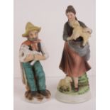 Two hand painted Continental pottery 20th century shepherd figurines, 21cm and 24cm respectively,
