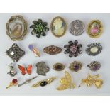 A quantity of vintage brooches including a Victorian spinning fob mourning brooch a/f having