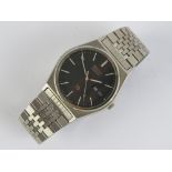 A Seiko Quartz 8023-6040 stainless steel wristwatch having black dial with day and date apertures,