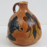 A Chameleon ware hand painted bottle vase with handle decorated in relief, standing 16cm high.