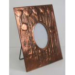 Arts and Crafts: a 19 th century copper easel photograph frame with chased decoration depicting