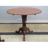An oval side table raised over hexagonal tapering stem on three outswept legs, 83 x 57cm.