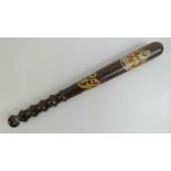 An early 20th century mahogany truncheon having crown and GR cypher upon, four finger turned grip,