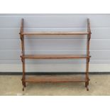 A late 19th century set of three hanging wall shelves in oak, 63cm high.