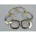 A silver bracelet of abstract form comprising six rectangular open panels, stamped 925, 19.