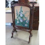 A fine Victorian free standing mahogany fire screen raised over opposing fine quality barley twist