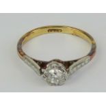 An 18ct gold and diamond solitaire ring, the round cut diamond in illusion setting of white metal,