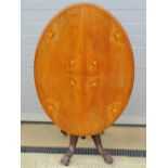A late Victorian oval tilt top table having inlaid boxwood decoration, quarter veneered,