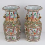 A pair of late 19th century Canton vases having figural scenes upon with gildd mythical creatures,
