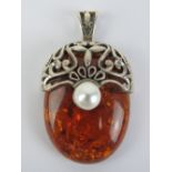 A large Baltic amber and silver pendant, stamped 925, 5.4cm in length inc bale.