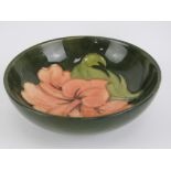 Moorcroft; a 'Hibiscus' pattern pin or trinket dish, salmon coloured flower on a green background,