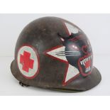 A US Vietnam helmet with stencilling on the front.
