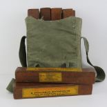 Eight inert blocks of US Army 2lb dynamite, dated 1944, in canvas carry bag.