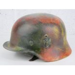 A WWII German M36 helmet originally having two decals (remnants to right side visible).