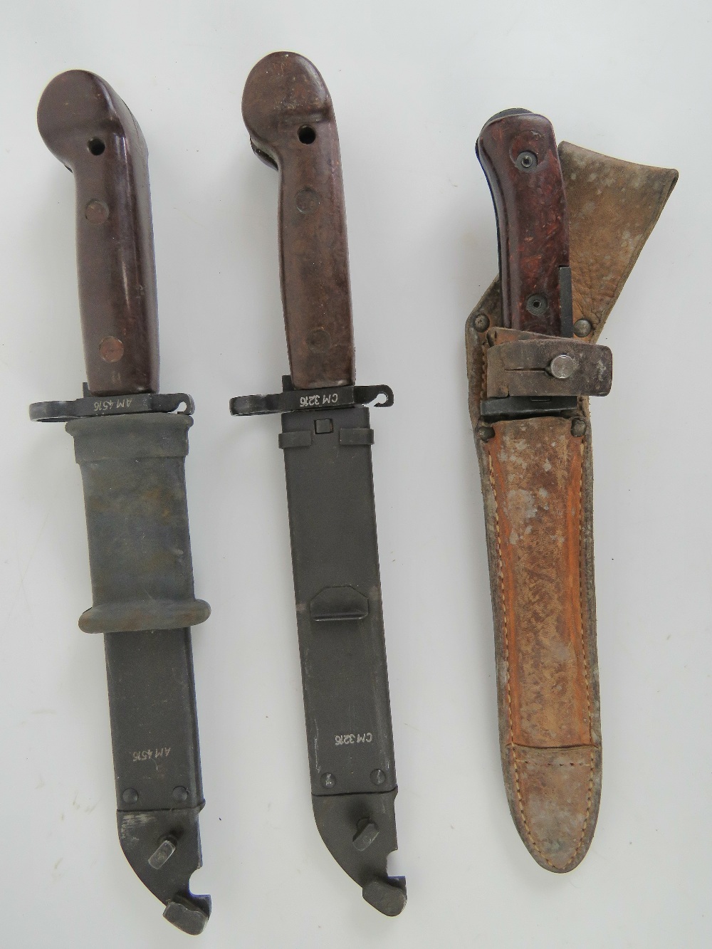 Two AK bayonets and a VZ58 bayonet with leather scabbard.