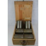 A WWII German 110mm wooden ammo crate containing six 110mm shells.