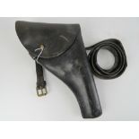 A brown leather holster dated 1935 with broad arrow upon, complete with belt.